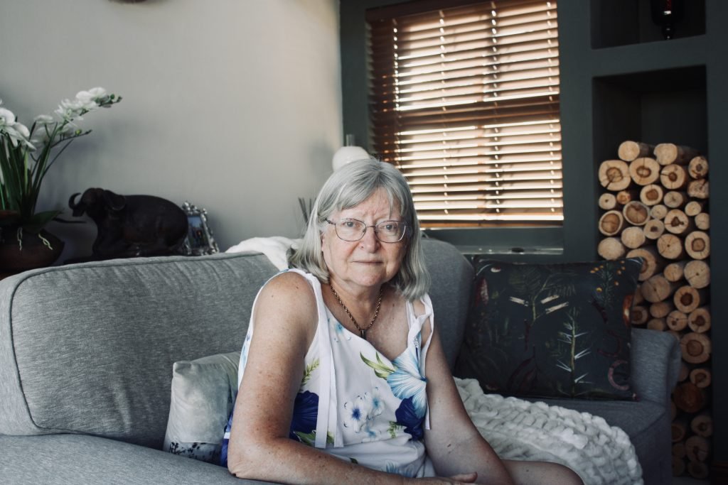 Joan sitting at home